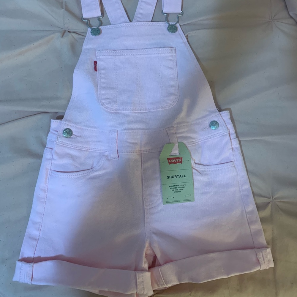 Girls pink Levi overalls.